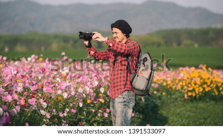 photographer taking photo of flowers mountain, landscape