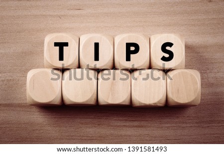 Four wooden blocks with Tips text of concept.