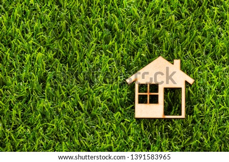 House in wood on green grass - Ecological concept