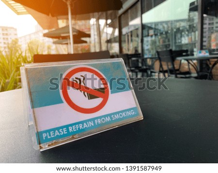 warning sign No smoking on wood table in coffee shop or public area for healthy of people surround