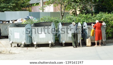 homeless people near the garbage cans