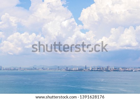 Cityscape of coastal city under the huge cumulus clouds at Pattaya, Thailand.