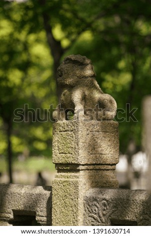 The old stone sculptures under the warm sunlight in one Chinese park