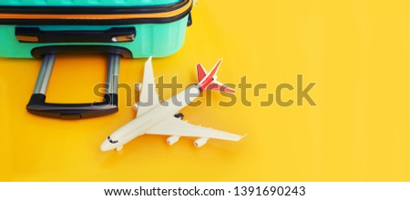 travel concept with suitcase over yellow background.