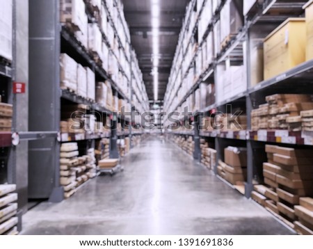 It is a warehouse of a large-scale shopping center, Rows of shelves with boxes, Blurred business background.
