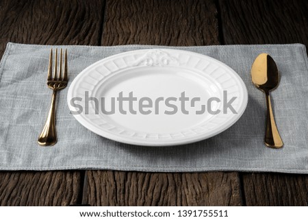 plate fork spoon on wood background clear and without depth of field