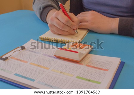 Close up view of bookkeeper or financial inspector hands making report, calculating or checking balance. calculator on the table