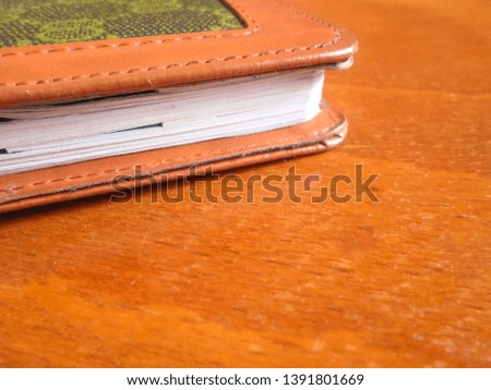 Closed book on the background of an old wooden table. Writers Desk.
