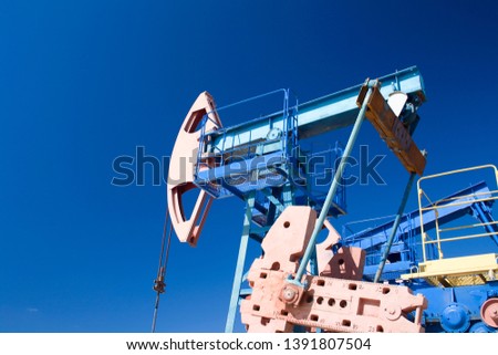 Oil and gas industry. Work of oil pump jack on a oil field. Wide angle