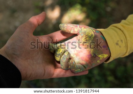 celebrate of the elders on the religious holidays.happy mother and teachers day.woman hold the rainbow painted kid hand.