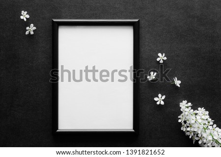Fresh white bird cherry on black, dark background. Condolence card. Empty place for emotional, sentimental text, quote, sayings or photo in frame.