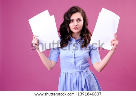 Young caucasian woman holding paper over pink background scared in shock with a surprise face, afraid and excited with fear expression