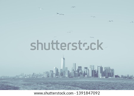 Panoramic view of lower Manhattan skyline from Staten Island, in New York, USA. Blue black and white image