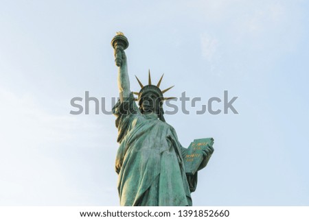 Statue of liberty on blue sky background.