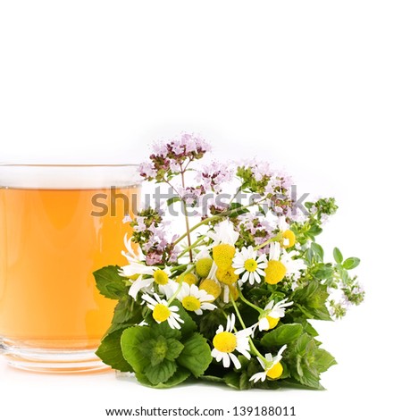 Herbal chamomile tea with origanum and mint isolated on white background