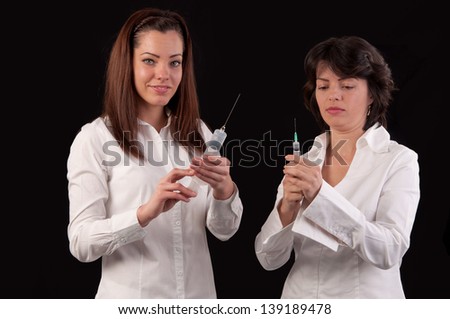 female doctor and nurse preparing to give an injection