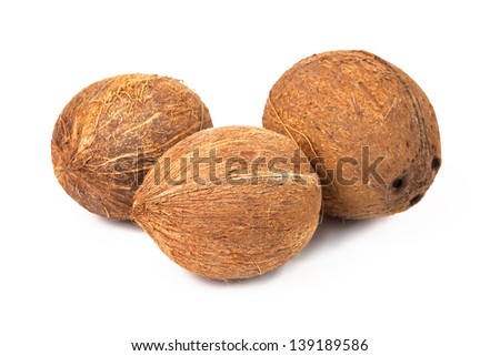 Three ripe coconuts isolated on white background.