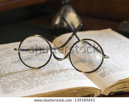 Picture of old glasses on a antique book