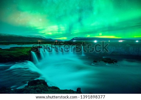 Northern Light, Aurora borealis at Godafoss waterfall in winter, Iceland. 