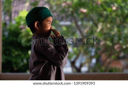Muslim boy praying in mosque