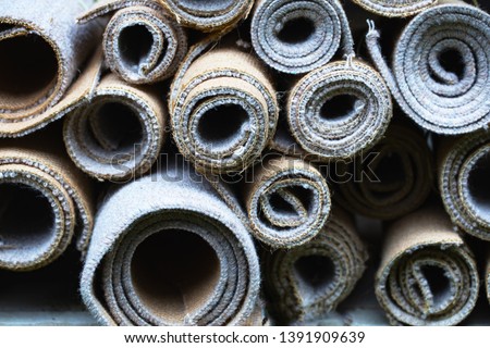 Cut up and rolled old carpets. Royalty-Free Stock Photo #1391909639