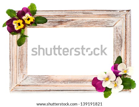 vintage wooden frame with pansy flowers isolated on white background