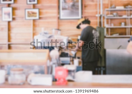 Abstract blur image of Barista preparing a coffee at the bar with bokeh for background usage. (vintage tone)
