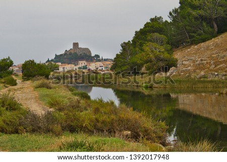 View along a drainage canal towards Barbarousse Castle, Gruissan
