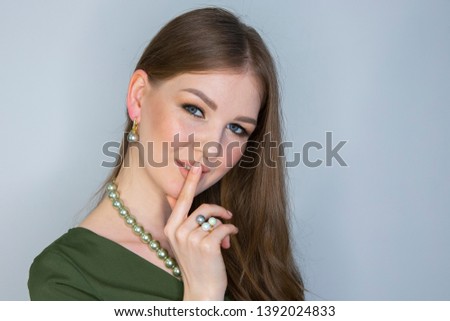 Attractive young girl touching her lips. Photo of blonde girl with perfect skin on grey background. Beauty Skin care concept Limited depth of field Close-up