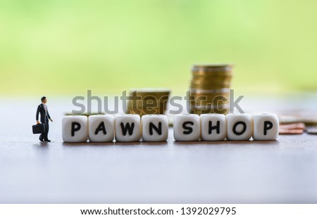 pawn shop concept / Businessman financial borrow loan pawn for cash with coin background  