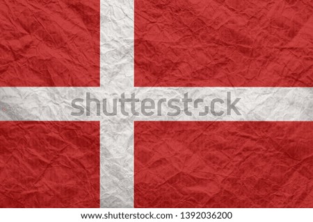 Denmark flag on old crumpled craft paper. Textured background wallpaper for design.