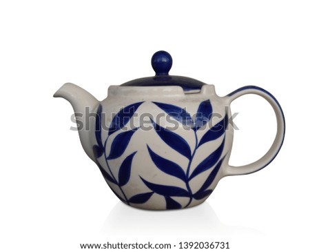 side view antique white and blue ceramic teapot on white background, copy space