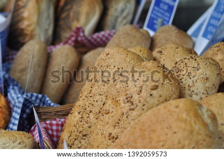 Seedy bread in baskets for sale at a farmers market. 