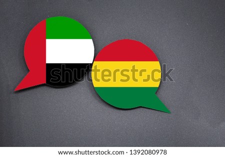 UAE and Bolivia flags with two speech bubbles on dark gray background