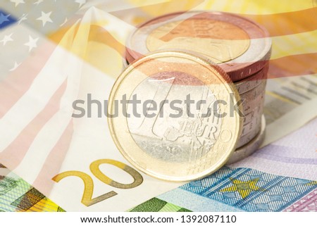 Euro coins and bills and flag of USA