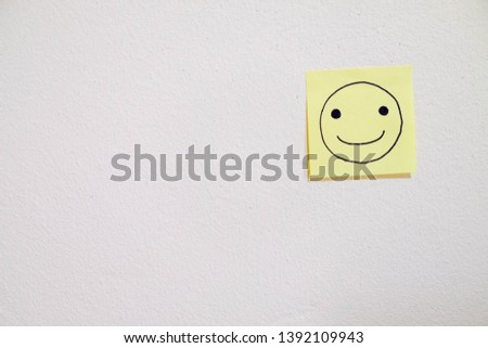 Drawing of smiling face on sticky paper