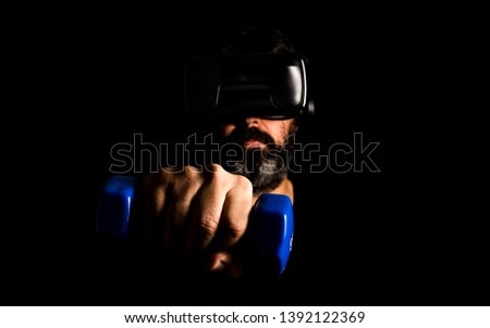 straight on picture of middle-aged man using virtual reality glasses to do sports activities with black background