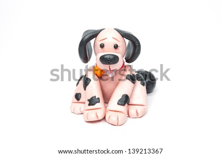 Dog sculpture with plasticine streaked with black dots.