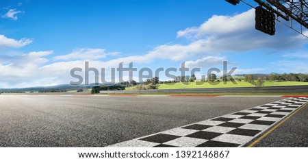 Wide angle view empty asphalt international race track with start and finish line , morning scene . Royalty-Free Stock Photo #1392146867