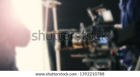 Blurry images of studio video shooting behind the scene or b-roll for online commercial and tvc which done by professional movie director film crew team and camera equipment with lighting set