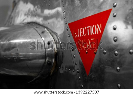 Ejection seat warning sign on the side of an airplane. Royalty-Free Stock Photo #1392227507