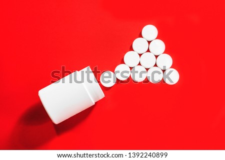 Pill bottle on red background for use in presentations, education manuals, design