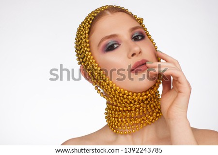 Creative portrait of an interesting woman in an unusual style using chaplet. Studio photo session. White background