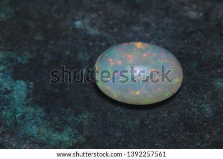 
Jewelry stone cabochon opal on a copper background