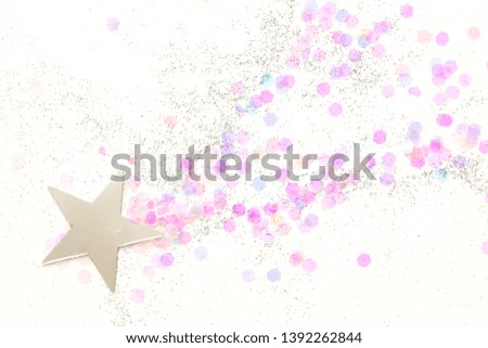 Confetti and silver stars on a white background, festive concept.  Perfect place for your design.
