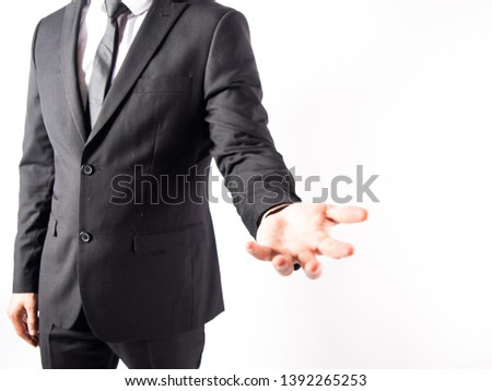 man wearing a suit showing his hand