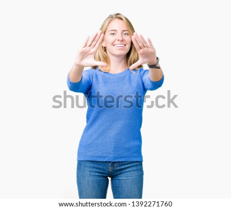 Beautiful young woman wearing blue sweater over isolated background Smiling doing frame using hands palms and fingers, camera perspective