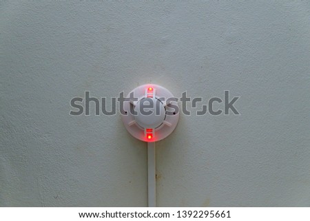 White smoke detector attached to the wall