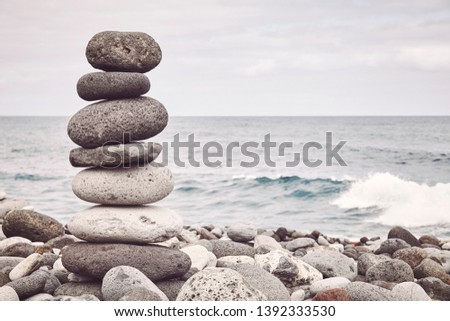 Color toned picture of a stone stack on a beach, balance and harmony concept, selective focus.