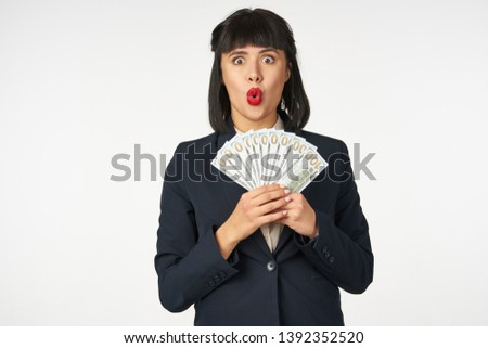   surprised woman with money on a light background                             